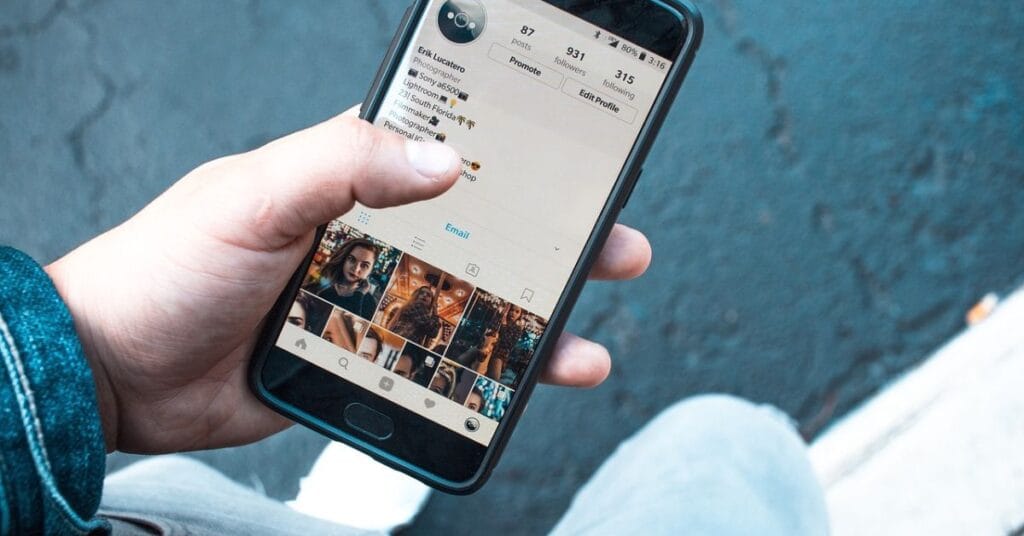 A person displaying a cell phone with a photo, exemplifying social etiquette in sharing moments with others.