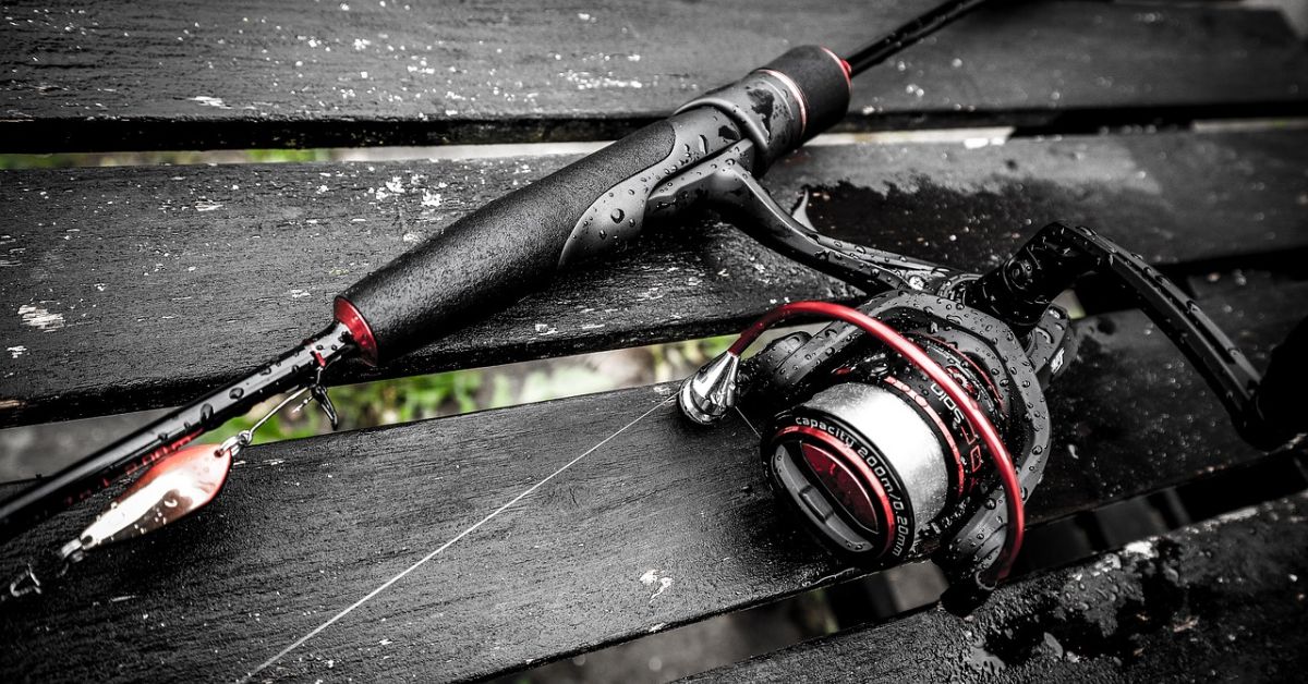 A fishing rod and reel resting on a bench, highlighting the potential for selling old fishing gear for profit.